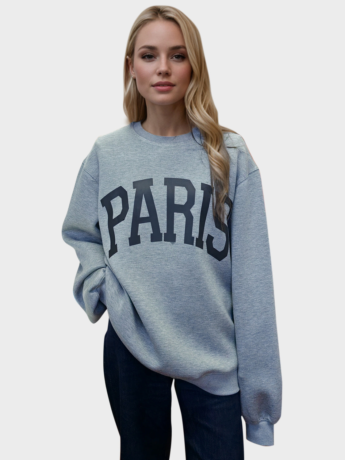 a blond girl wearing a paris sweatshirt