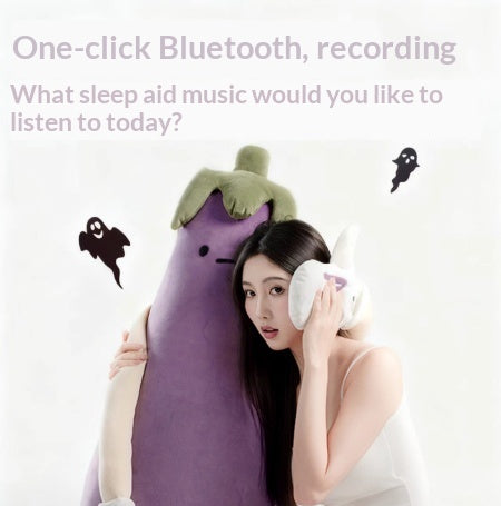 Person holding a pbluetooth plush toy shaped like an eggplant with a headband,