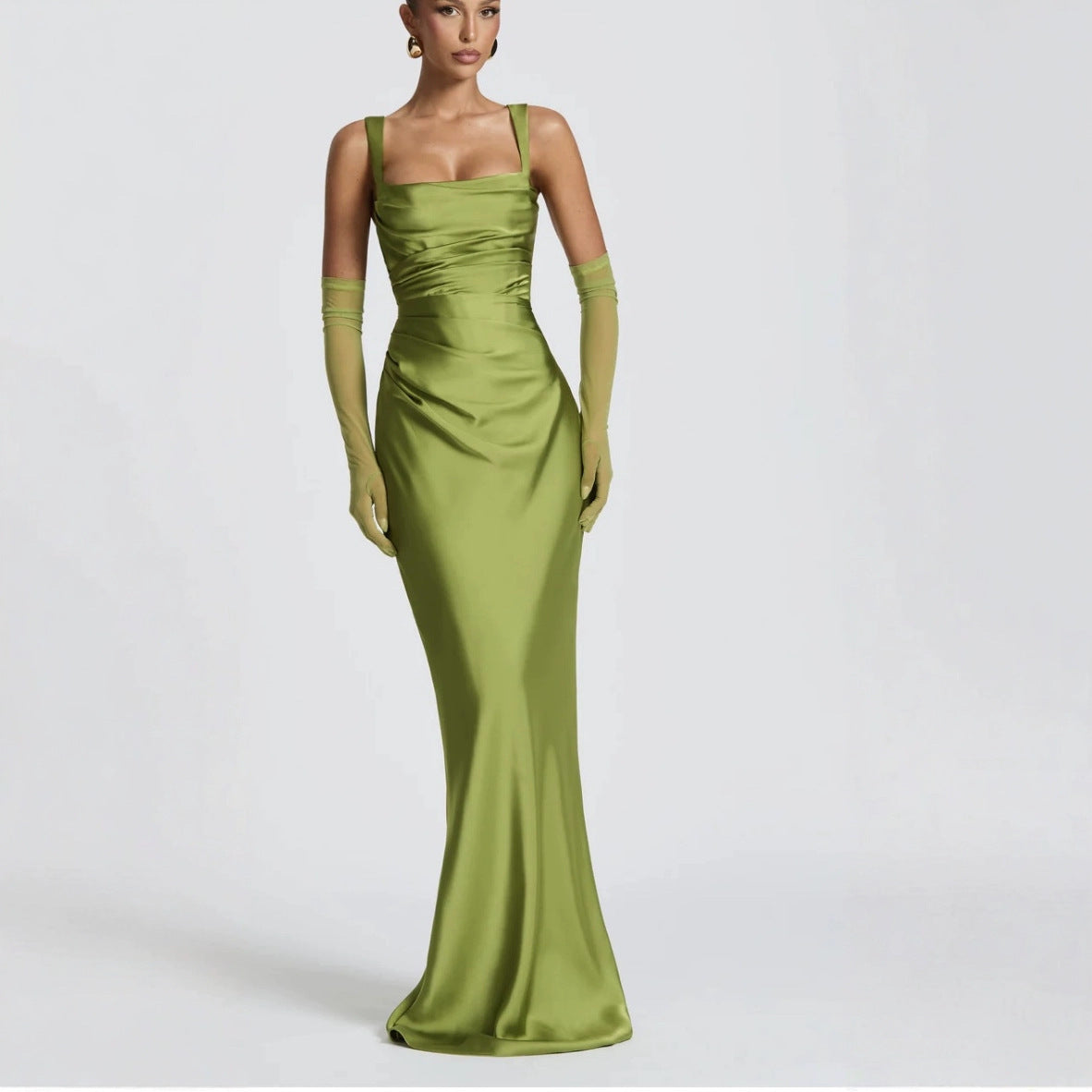 Woman wearing a green evening gown with matching gloves perfect for new year party