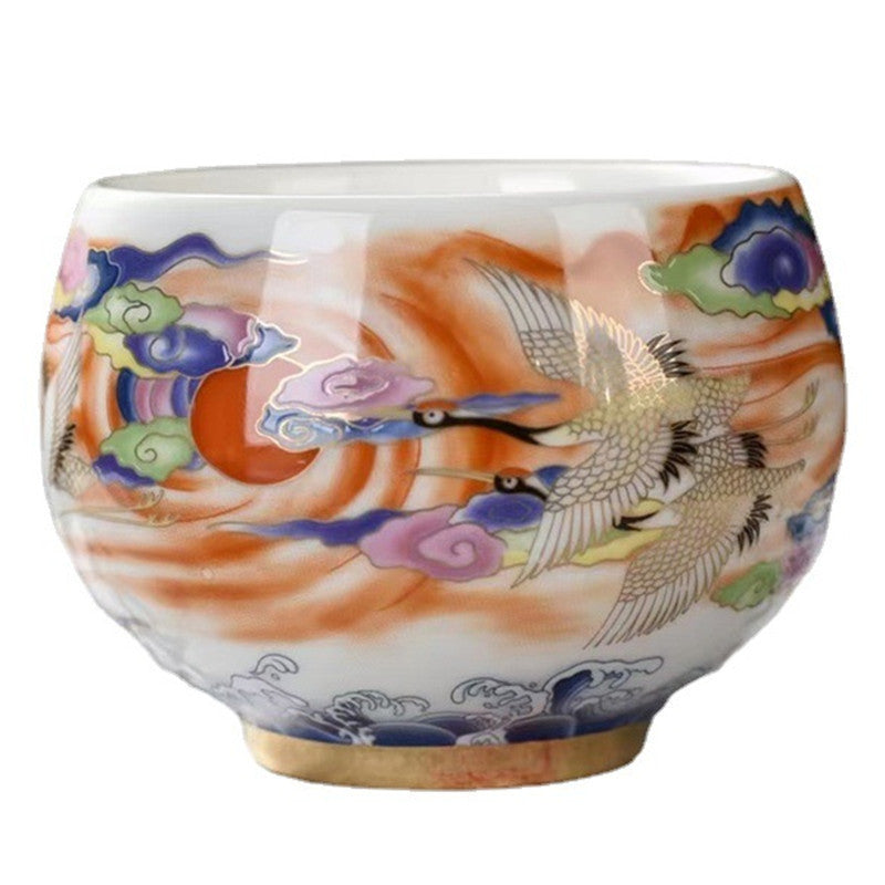 Close-up of crane and cloud motifs on ceramic tea cup