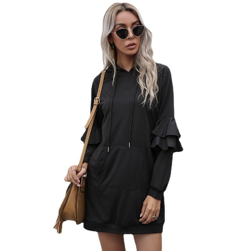 Close up of patchwork detailing on hoodie black dress with ruffled sleeves