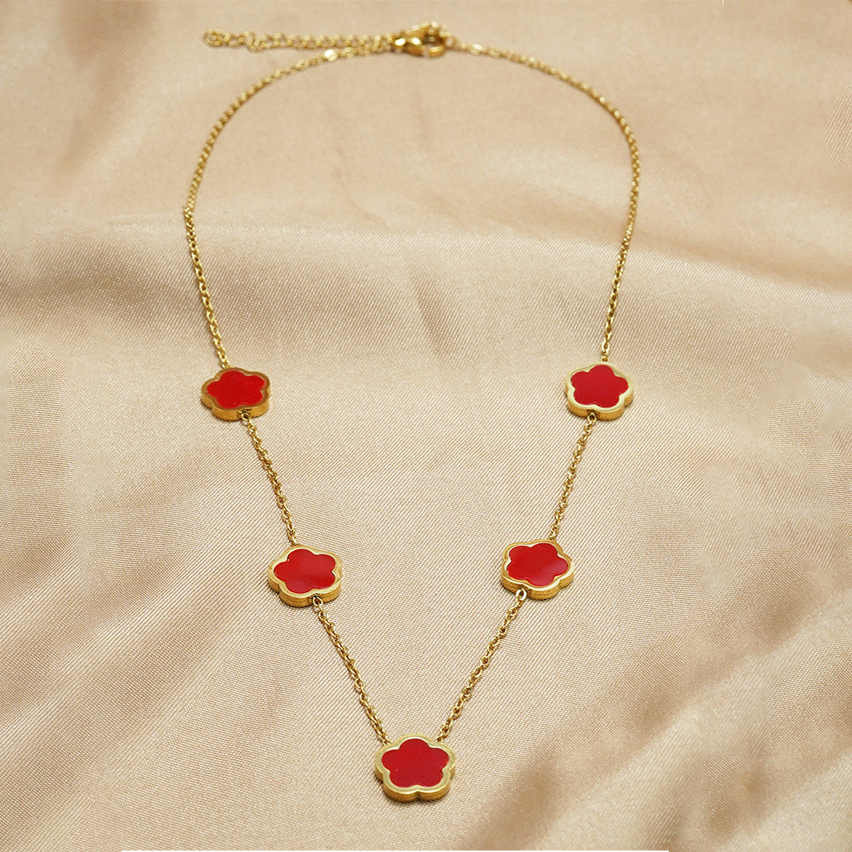 Gold necklace with five red flower design
