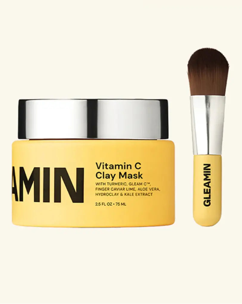 Gleamin Vitamin C Clay Mask with a brush on a white background, featuring the Vogue logo.