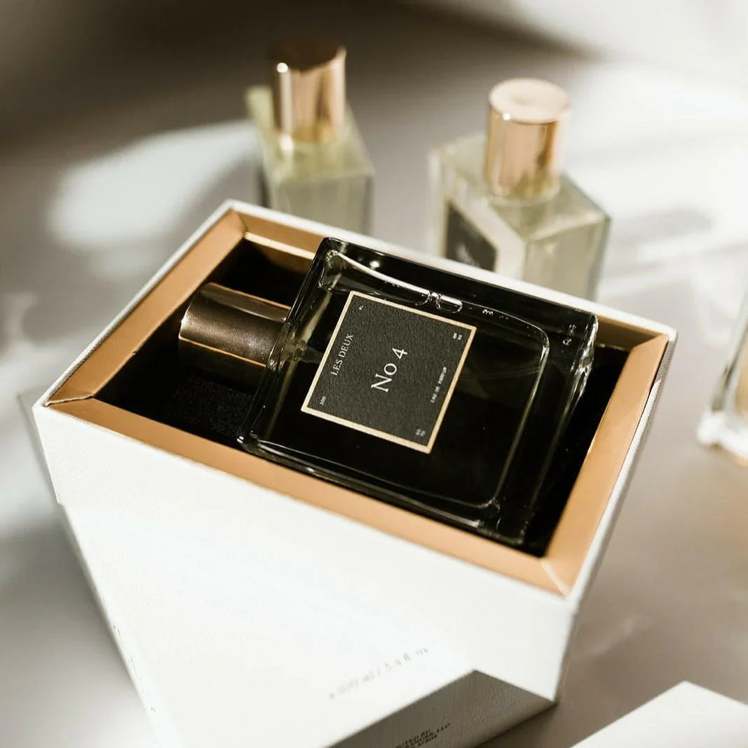 Perfume bottle labeled 'No 4' in a decorative box with gold accents  christmas gift