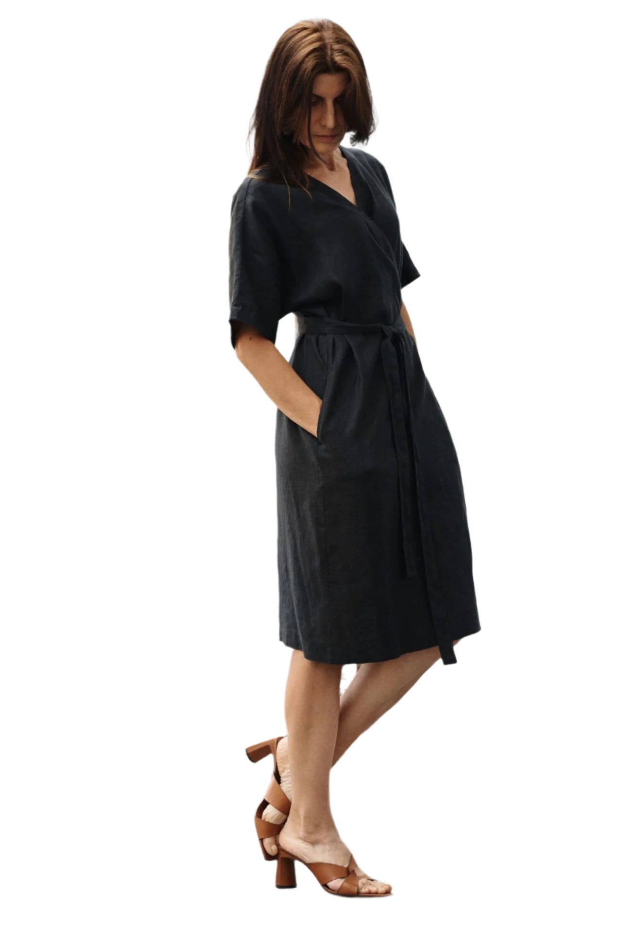 Model wearing versatile linen wrap dress with adjustable waist tie