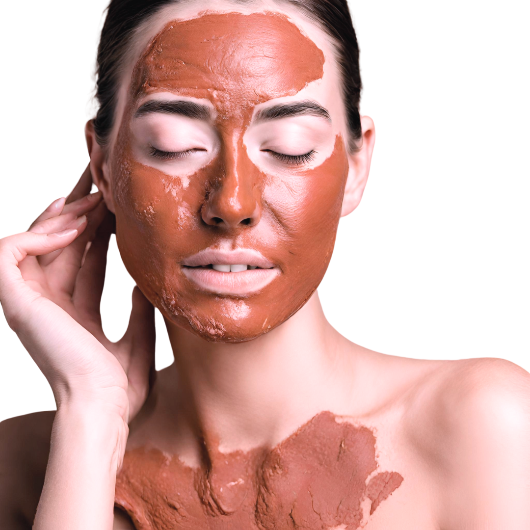 Woman with a brown clay mask on her face and shoulders