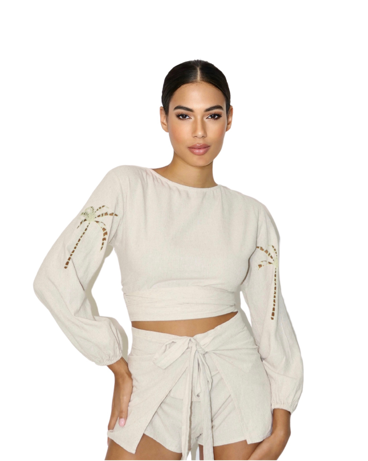 Woman wearing a white long-sleeve top and shorts set on a white background