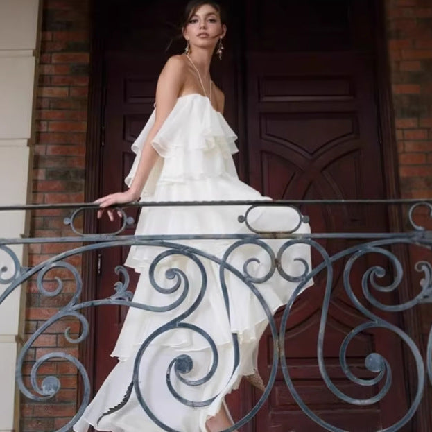 Woman with a white long ruffle coktail dress 