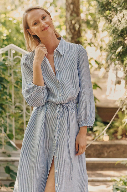 A woman wearing a blue linen dress made in  Italy 