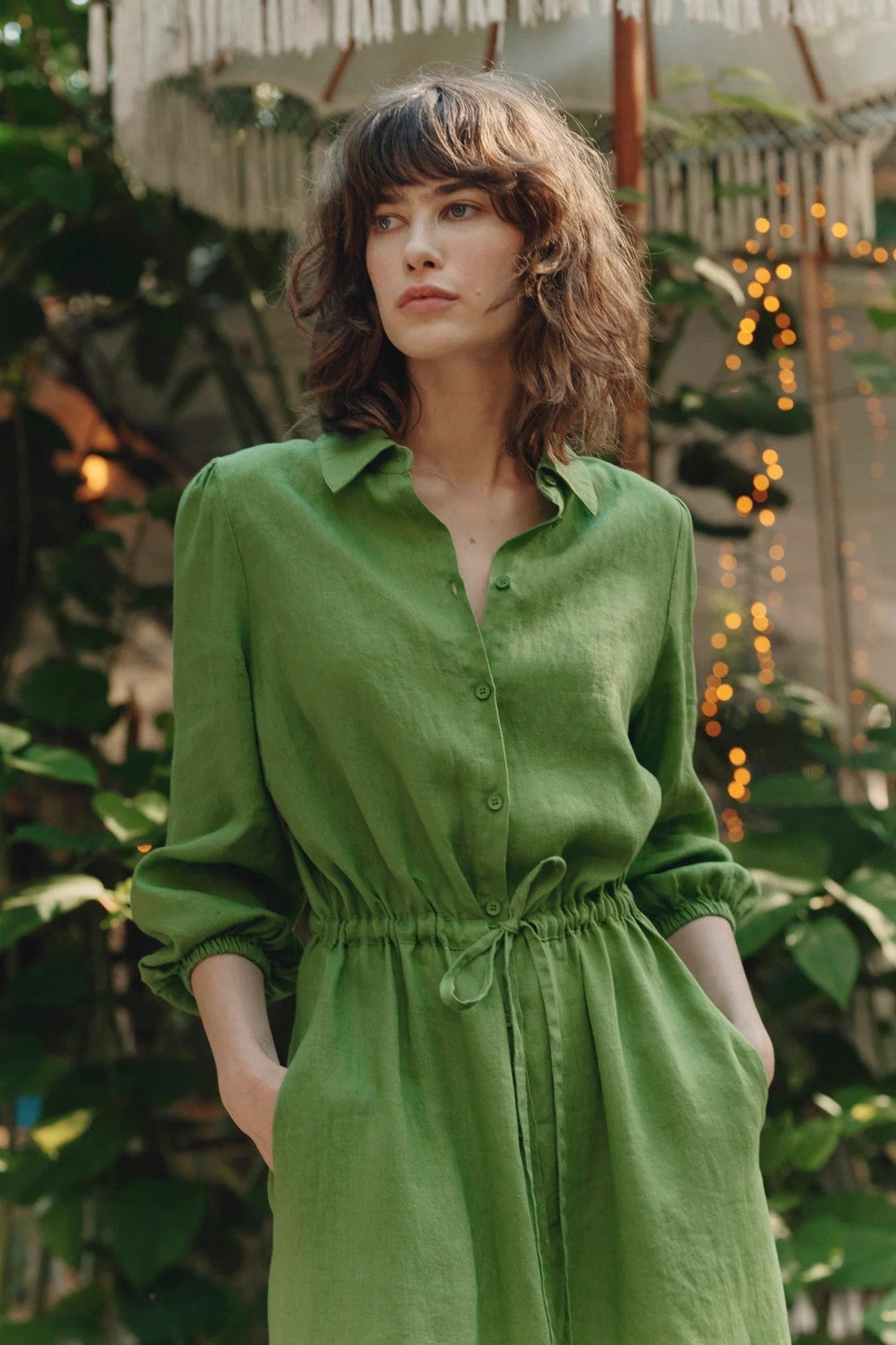 A model wearing a green linen dress 