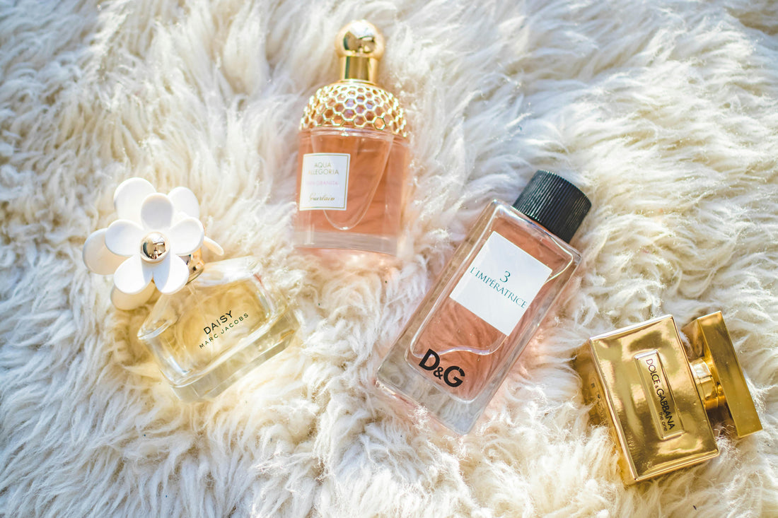Elegant perfume bottles arranged on a white cloth – luxury scent collection"