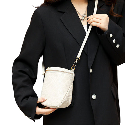 White mini handbag showcasing premium top-layer material with metal accents

