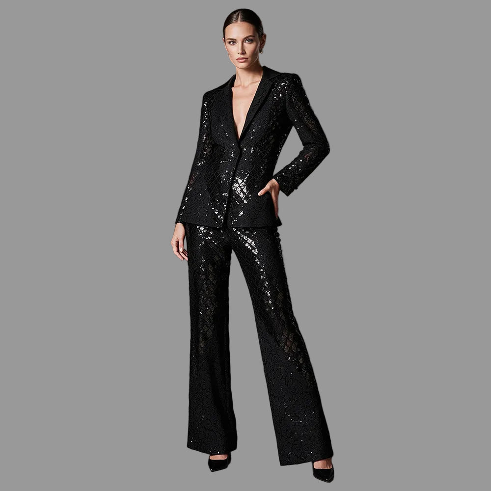 Front view of a black sequin lace pantsuit with satin lapels and wide-leg trousers on a model.
