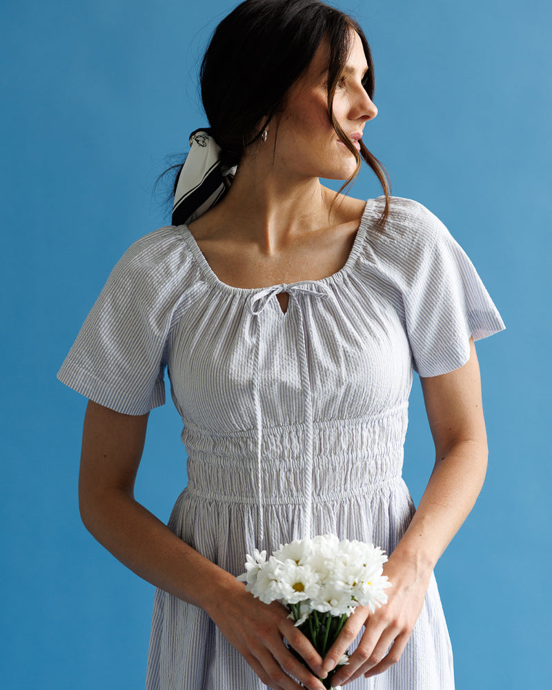 Woman in a romantic white dress holding flowers 