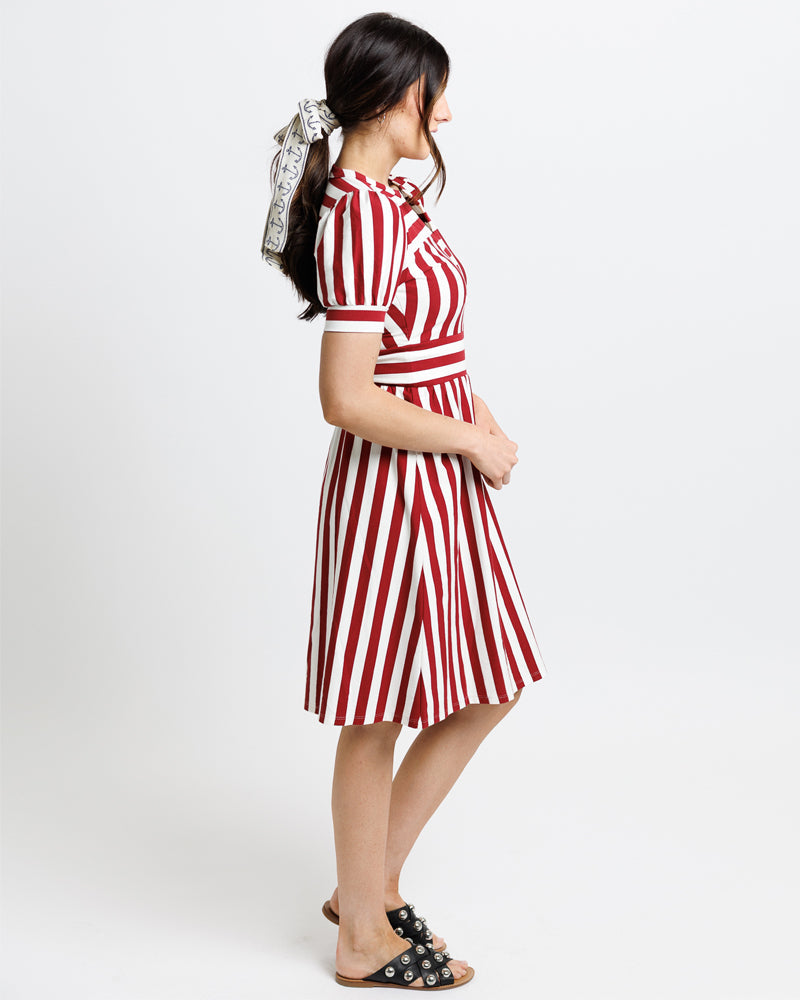 Woman wearing a red and white striped dress  with short sleeves