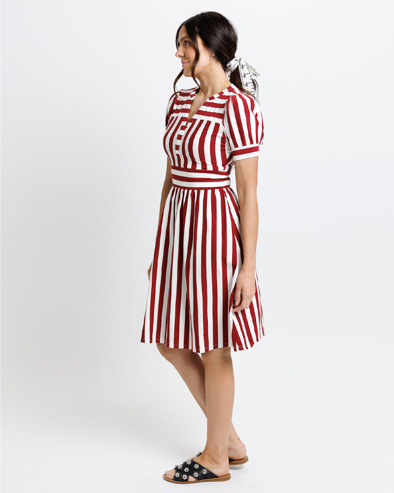 Woman wearing a red and white comfortable all in cotton striped dress 