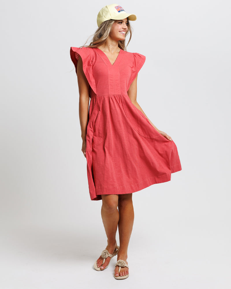 Woman wearing a red dress with ruffled sleeves 