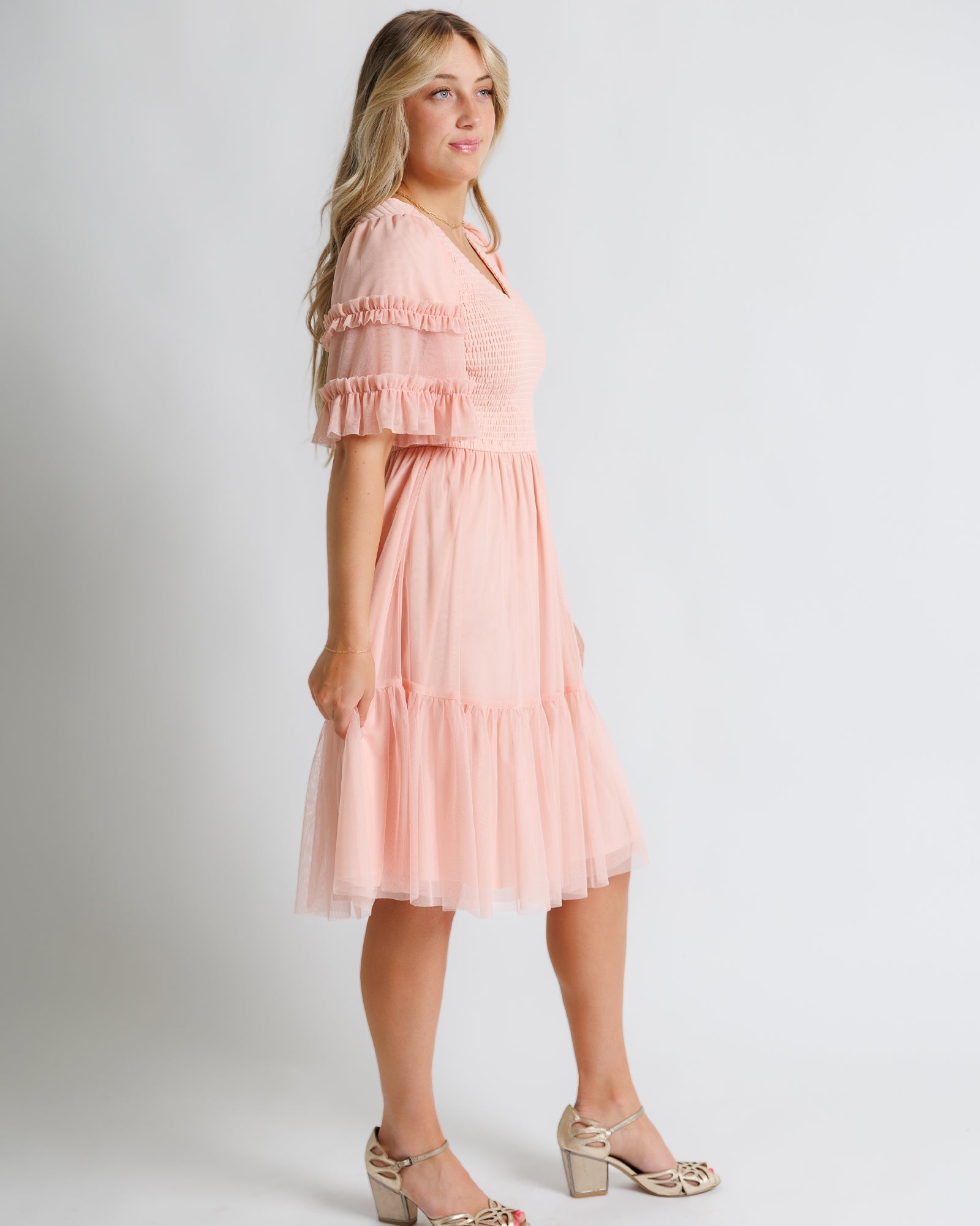 Woman wearing a pink  ruffle dress 