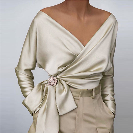 Women wearing beige off-shoulder wrap blouse with tie-front detail and long sleeves

