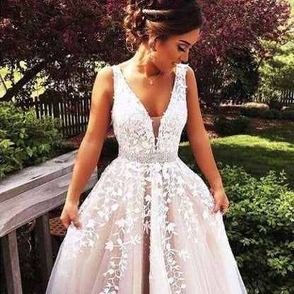 Woman wearing a white lace dress in an outdoor setting