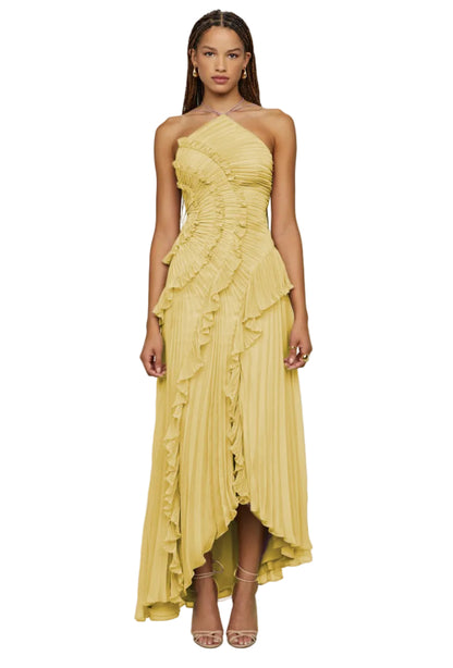 Woman wearing a yellow strapless dress with ruffled layers for an elegant evening night out 