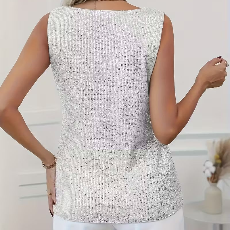 
Sequin sleeveless blouse styled with high-waisted jeans for casual glam look

