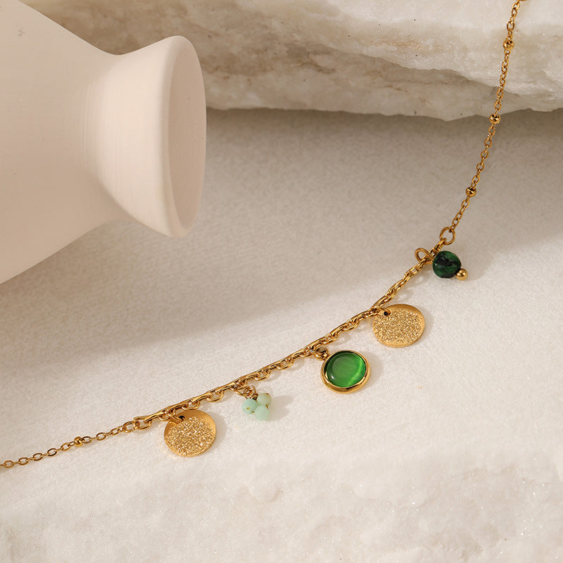 Gold bracelet  with green gemstones 