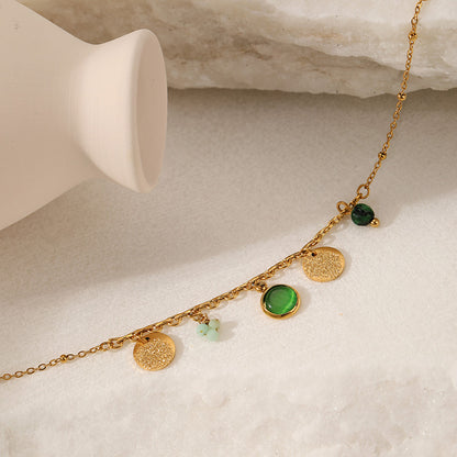 Gold bracelet  with green gemstones 