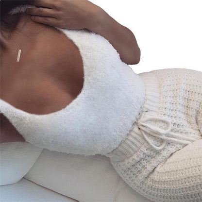Close-up of a person wearing a white textured top and beige knit skirt on a white background