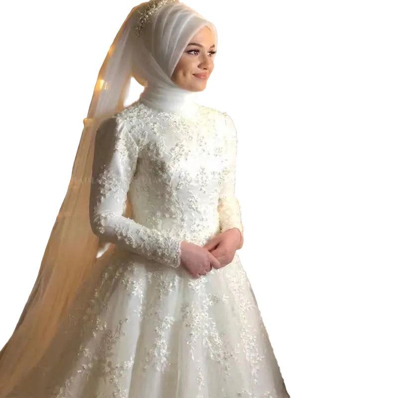 Woman in a white embroidered wedding dress with a long veil 