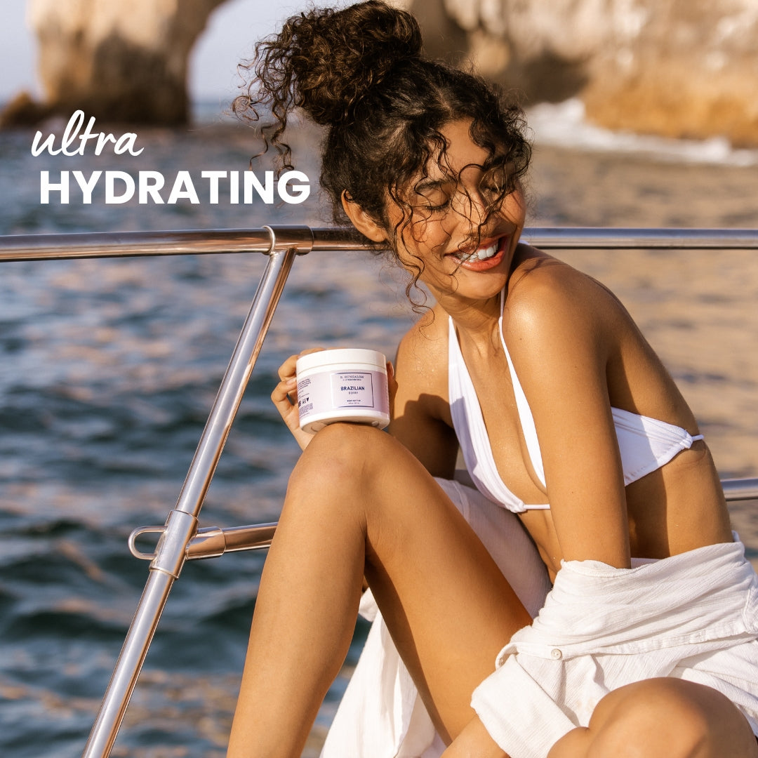 Woman on a boat holding a jar of ultra hydrating cream 