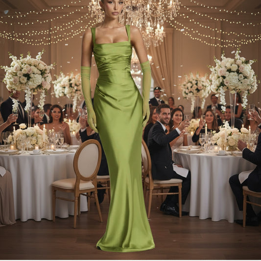 Woman wearing a green evening gown with matching gloves , best wedding guest dress 
