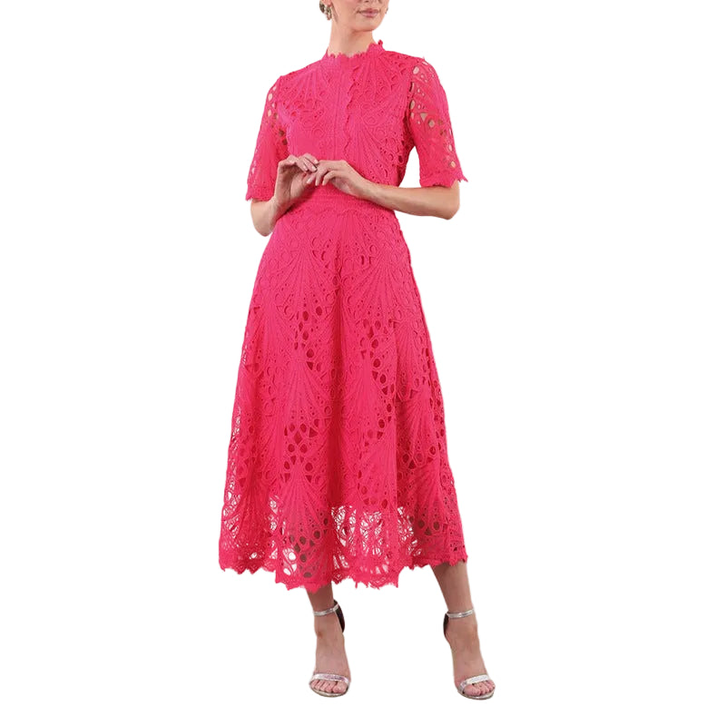 Woman wearing a bright pink lace dress 