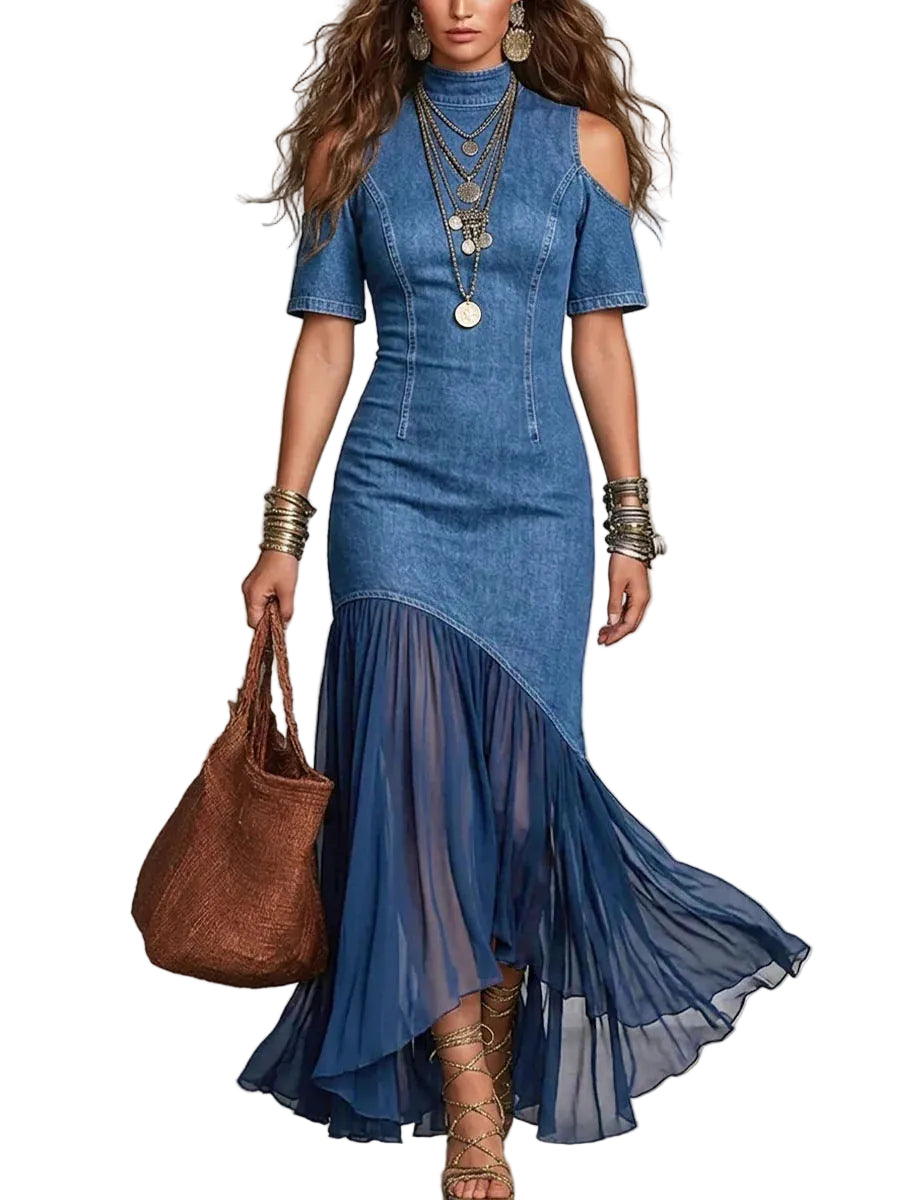Woman wearing a blue denim dress with sheer overlay holding a brown handbag 