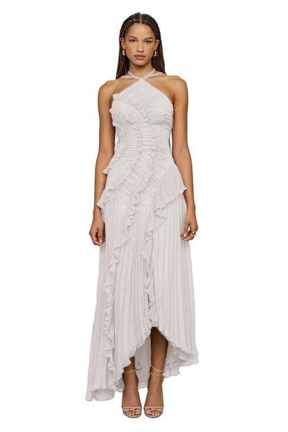 Woman wearing a white halter neck dress with ruffled layers 