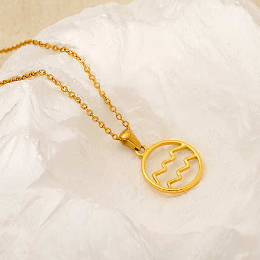 Gold necklace with a circular zodiac pendant 