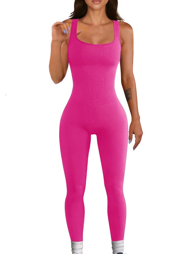 Woman wearing a bright pink ribbed jumpsuit 