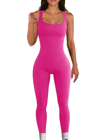 Woman wearing a bright pink ribbed jumpsuit 