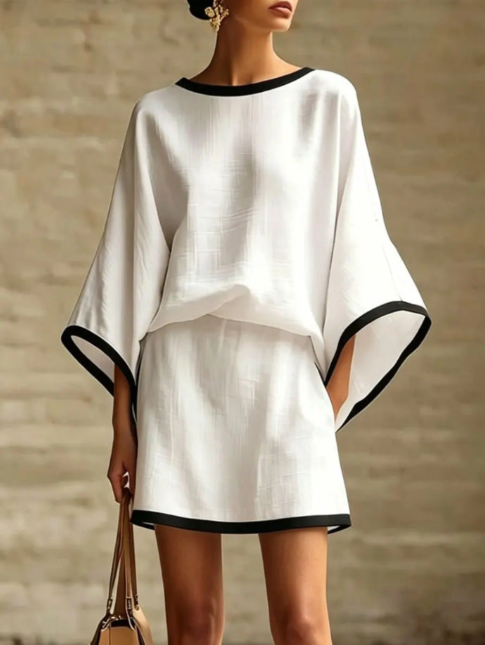 Woman wearing a white outfit with black trim in cotton linen 