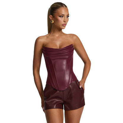 Woman wearing a strapless maroon leather short outfit 