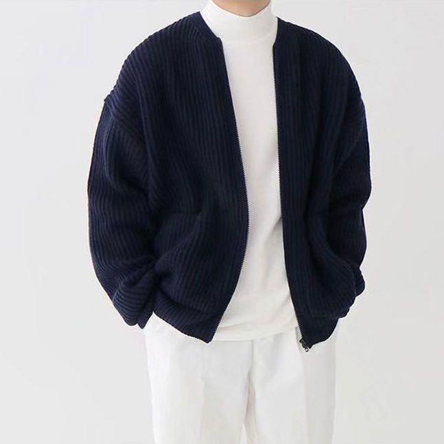 Navy blue cardigan over a white turtleneck and pants 