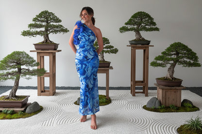 Woman wearing a blue floral one-shoulder silk elegant  one shoulder dress  