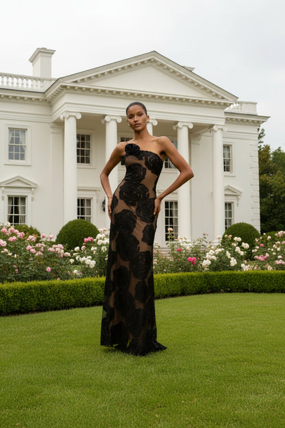 Woman wearing a black floral elegant evening gown 