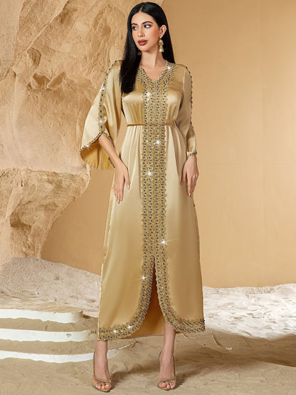 Woman wearing a gold dress Embellished Satin Kaftan Abaya 