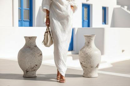 Elegant white maxi dress showing off-shoulder neckline and flowing A-line silhouette


