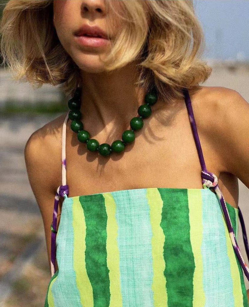 Woman wearing a green beaded necklace 
