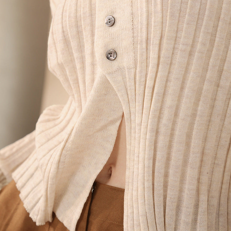 Close-up of a beige ribbed sweater with buttons 