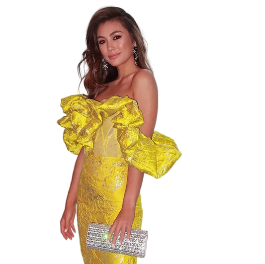 Bold yellow jacquard dress showing sculptural puff sleeves and fitted bodice

