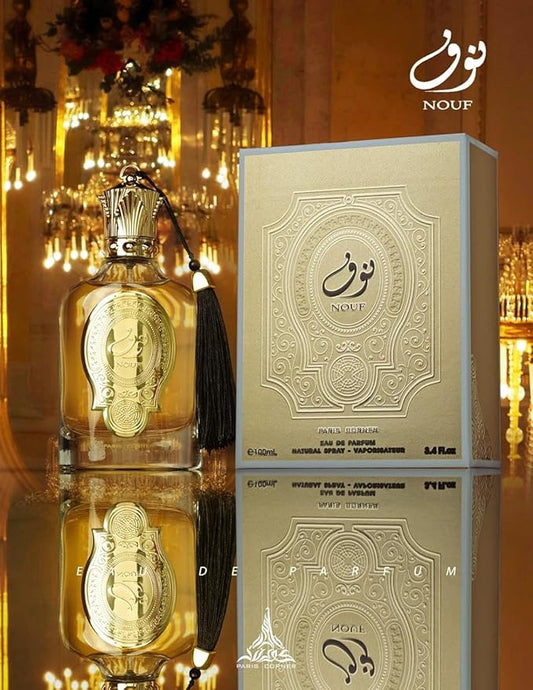 Gold perfume bottle and box with 'Nouf' branding on a reflective surface.