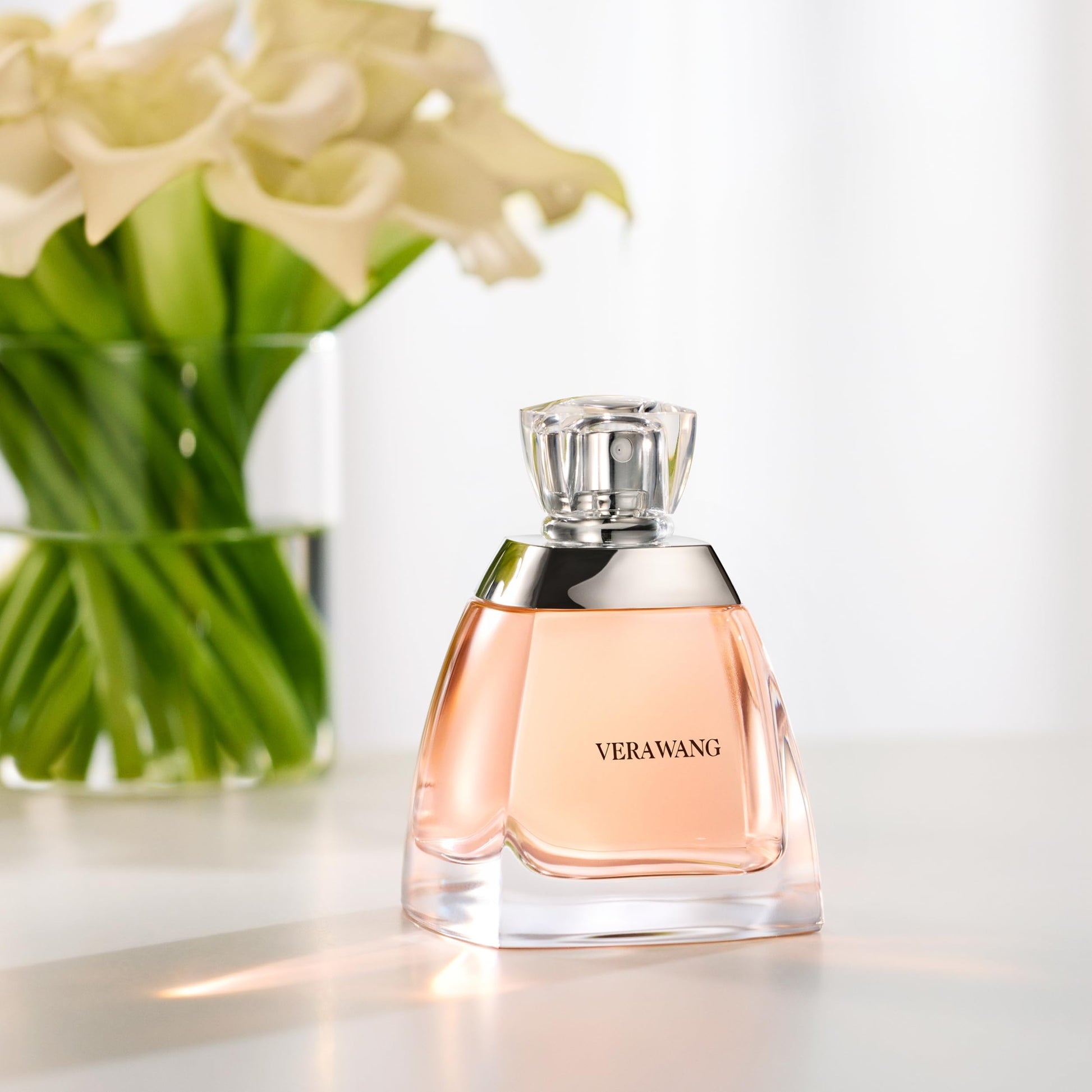 Perfume bottle with flowers in the background

